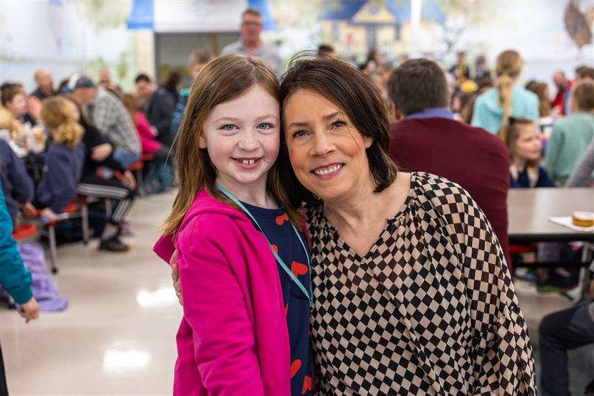 Students and their families enjoy donuts